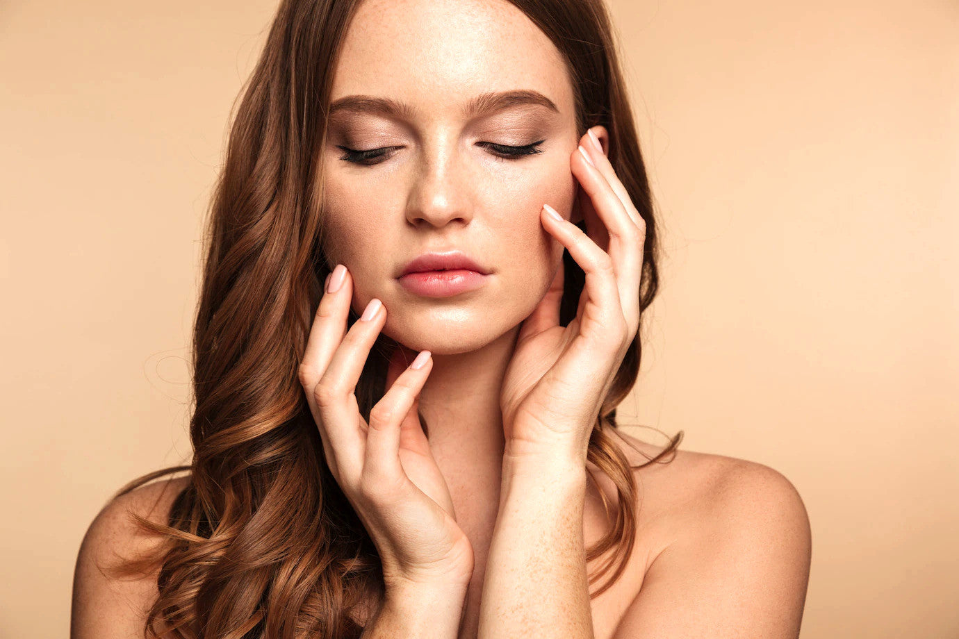 Young woman with glowing skin gently touching her face using organic plum facial serum for anti-aging skincare