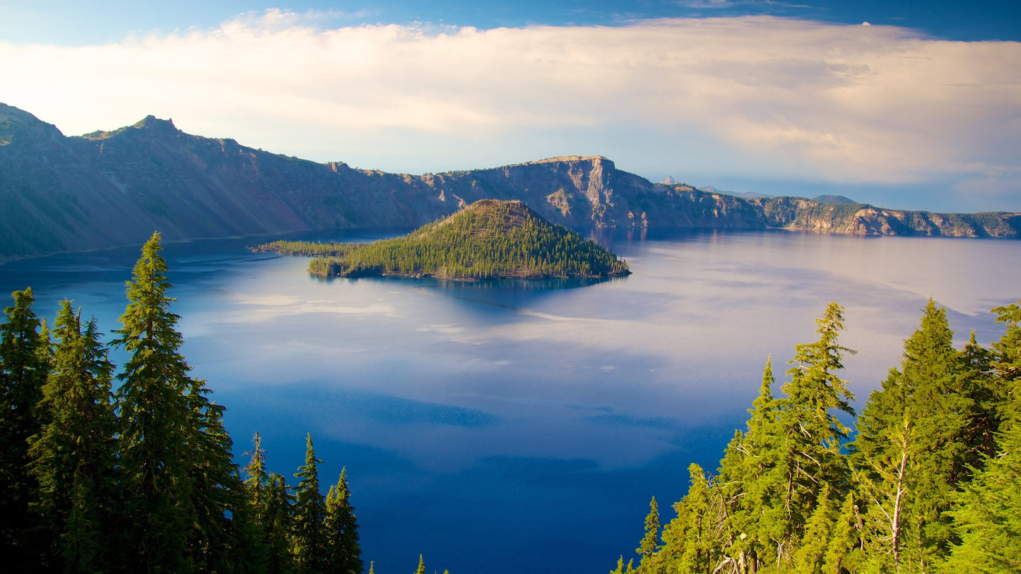 Scenic view of a lake surrounded by mountains and pine trees representing natural source for organic Klamath supplement