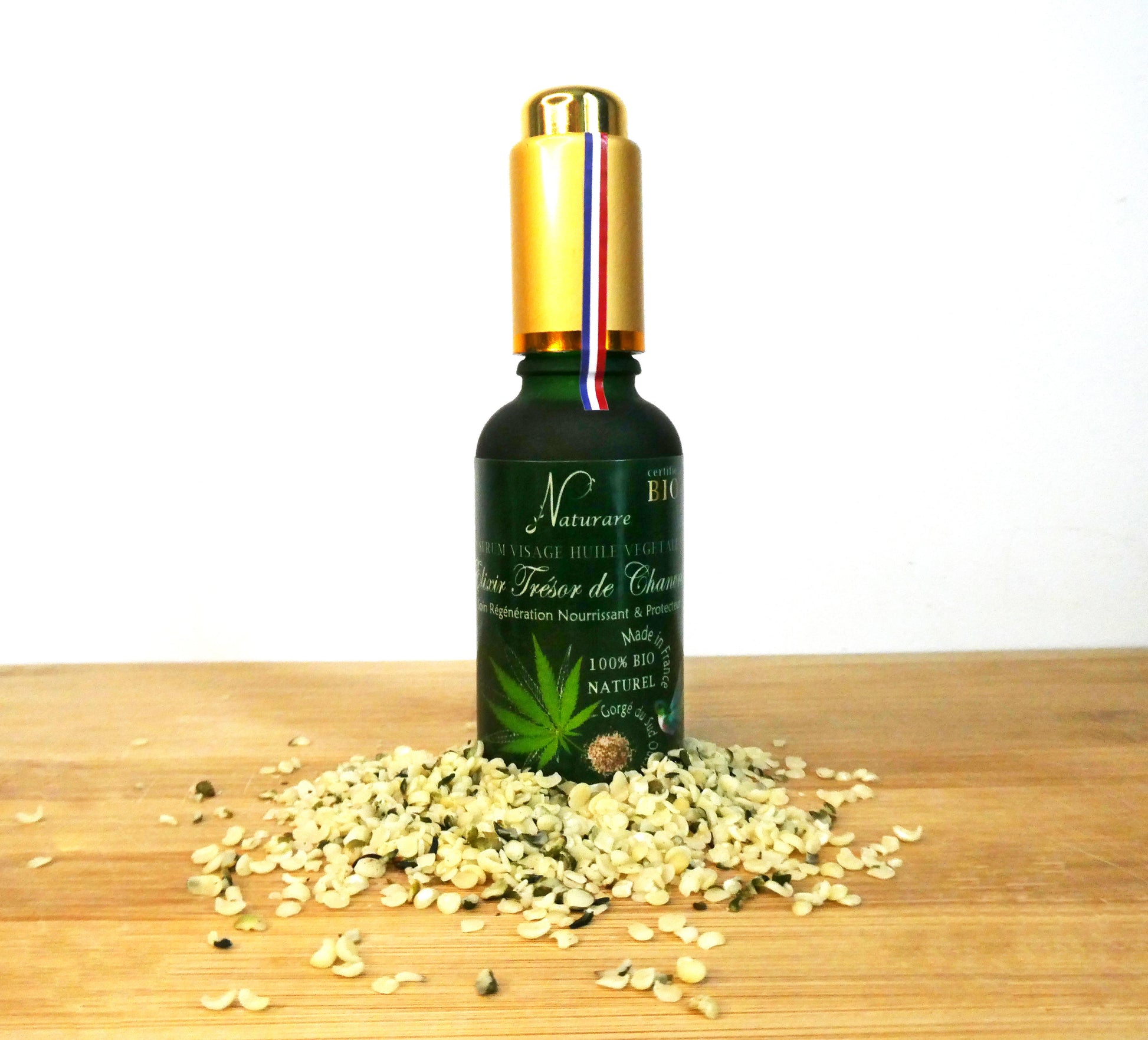 Naturare.fr anti-aging serum bottle surrounded by natural seeds French natural skincare elixir