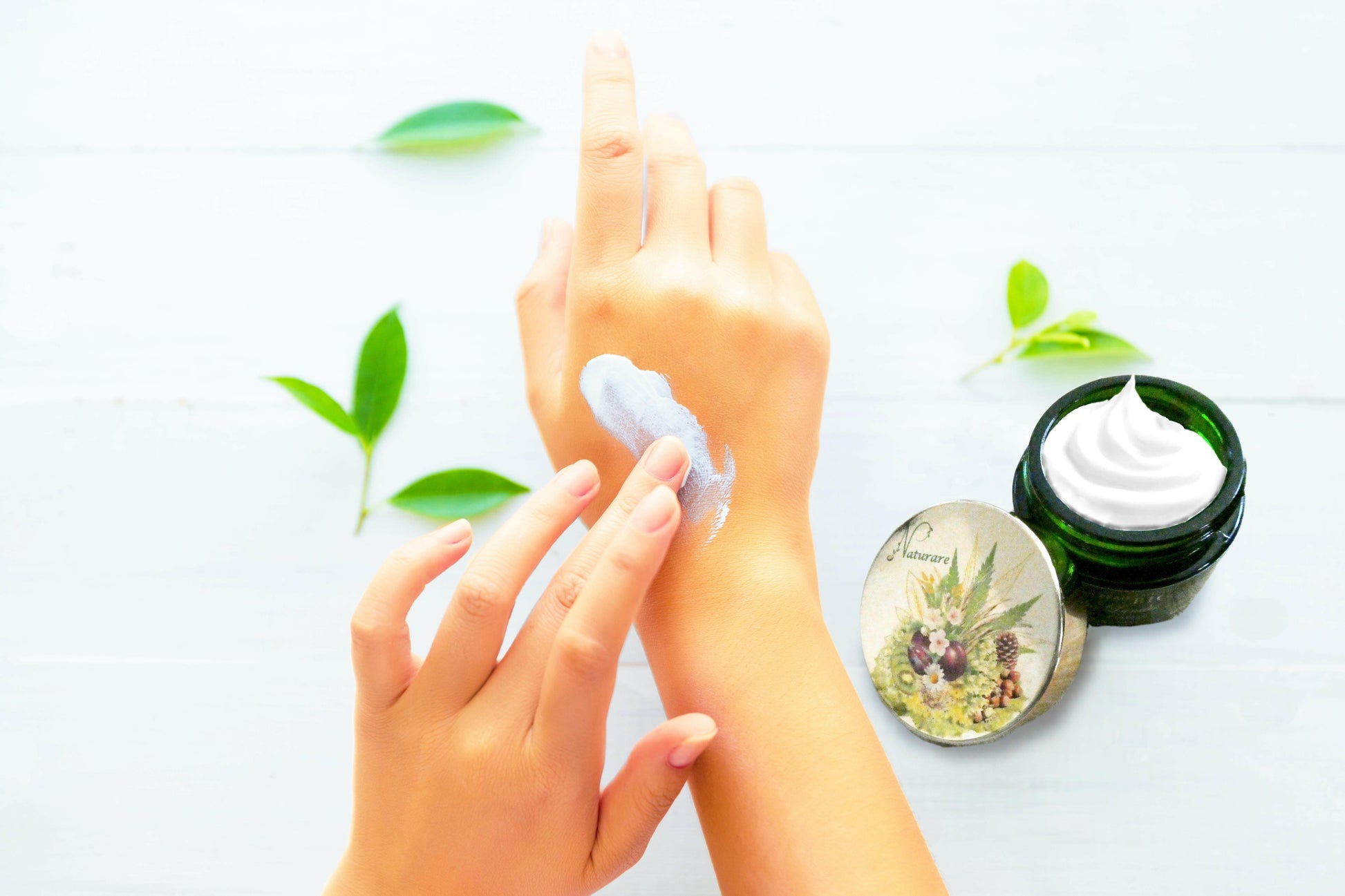 Agnès' Petit Paris Skincare Prix PRO natural bust enhancement skincare cream being applied on hand with green leaves background