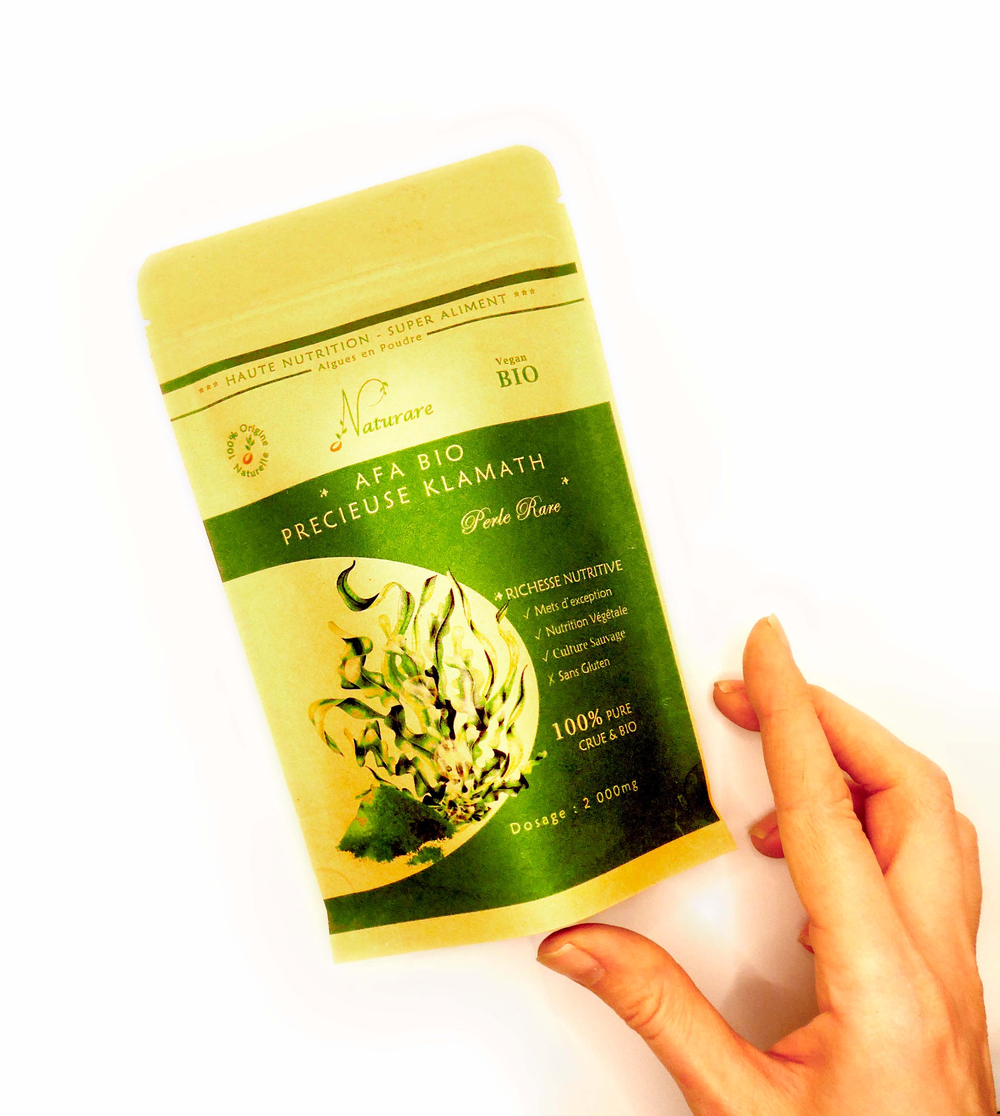 Hand holding a green and yellow package of Cosmétiques Naturels BIO with PERFECTING BOX for radiant skin