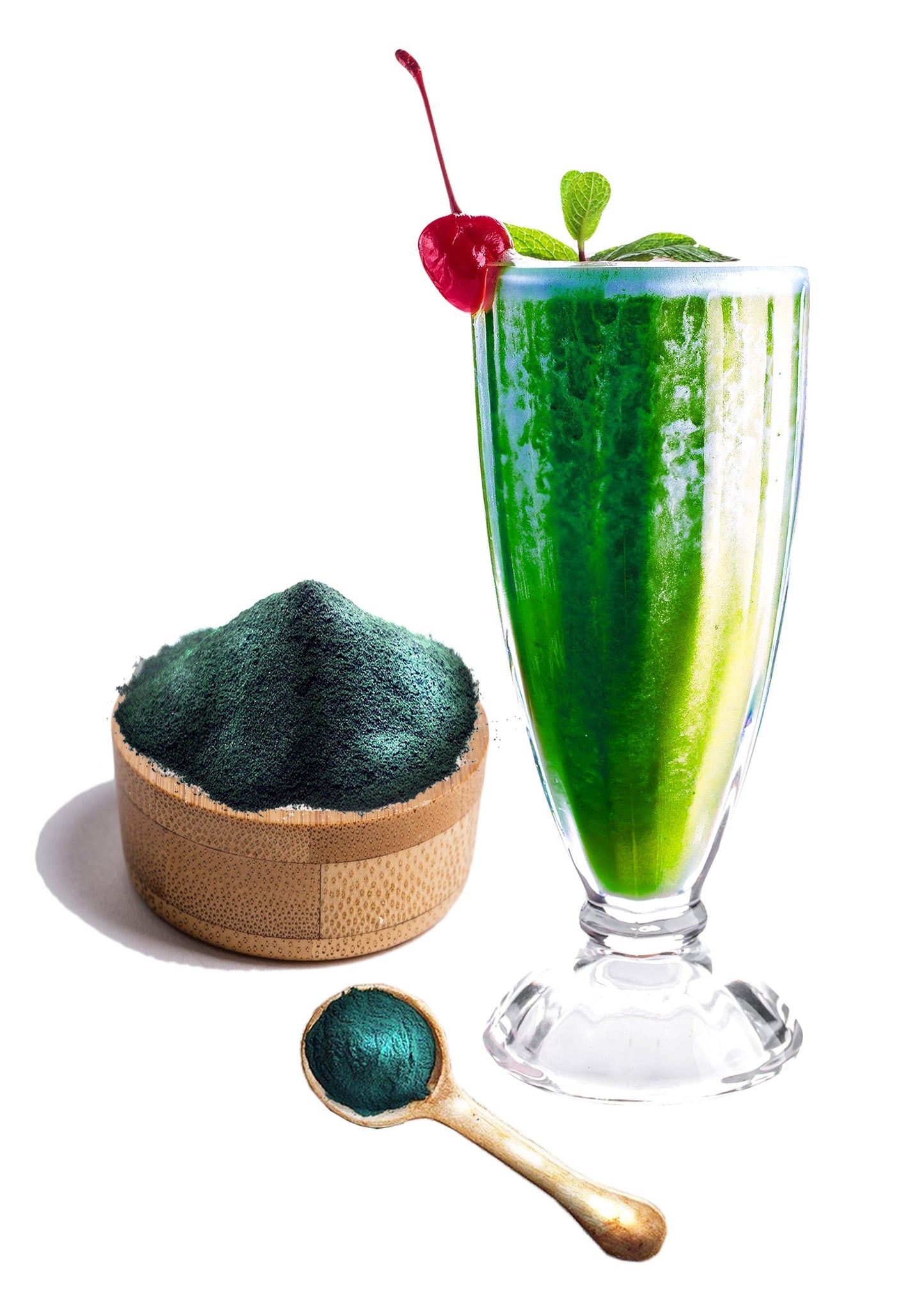 Green smoothie with fresh mint and cherry next to spirulina powder and wooden spoon from PERFECTING BOX for radiant skin
